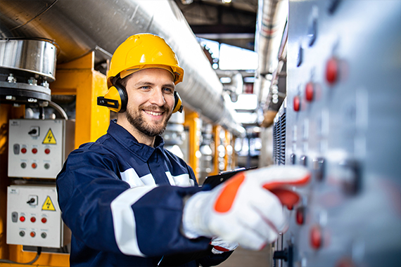 Engineer Operating Industrial Control Panel In Factory
