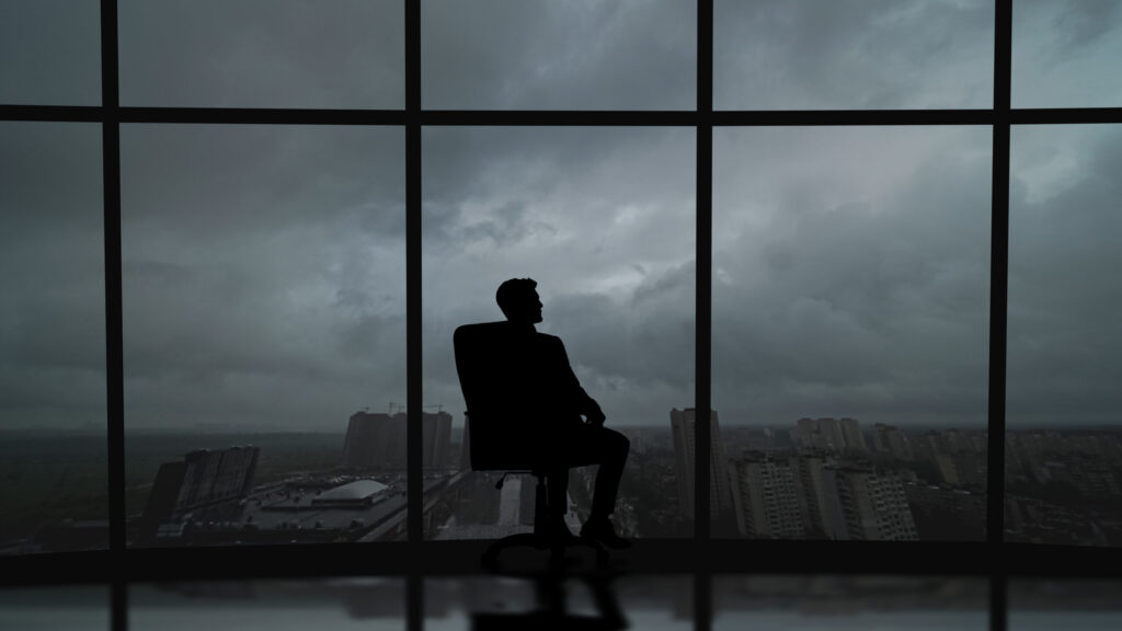 The Business Man Is Sitting In The Office Near The Window With A