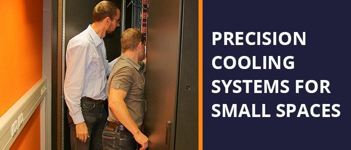 two men looking at a precision cooling system